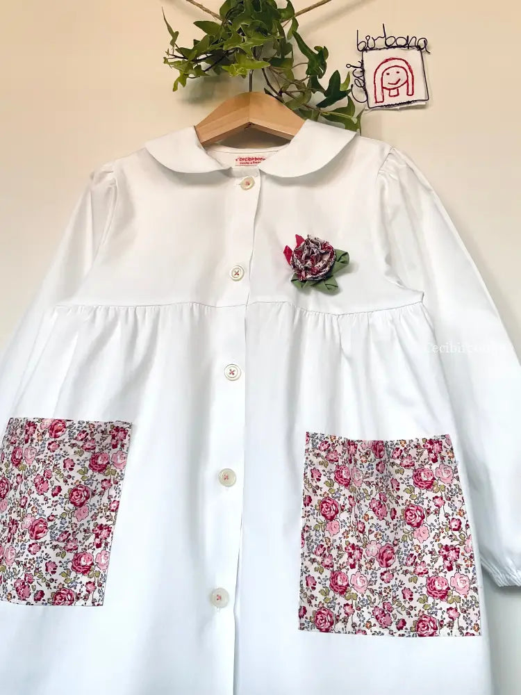 Il grembiulino con le rose e i lillà - Grembiule bianco per asilo con tasche a fiorellini rosa e colletto tondo