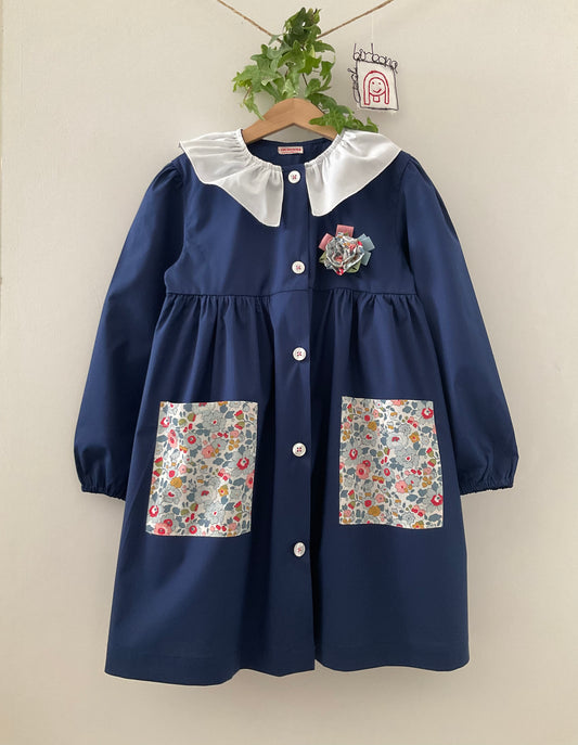 The blue apron with light blue and pink flowers and pierrot collar for primary school